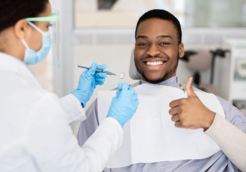 Happy,Black,Male,Patient,Showing,Thumb,Up,While,Having,Check